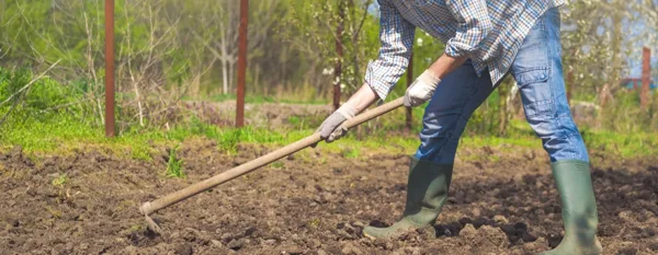 farmer using a garden hoe