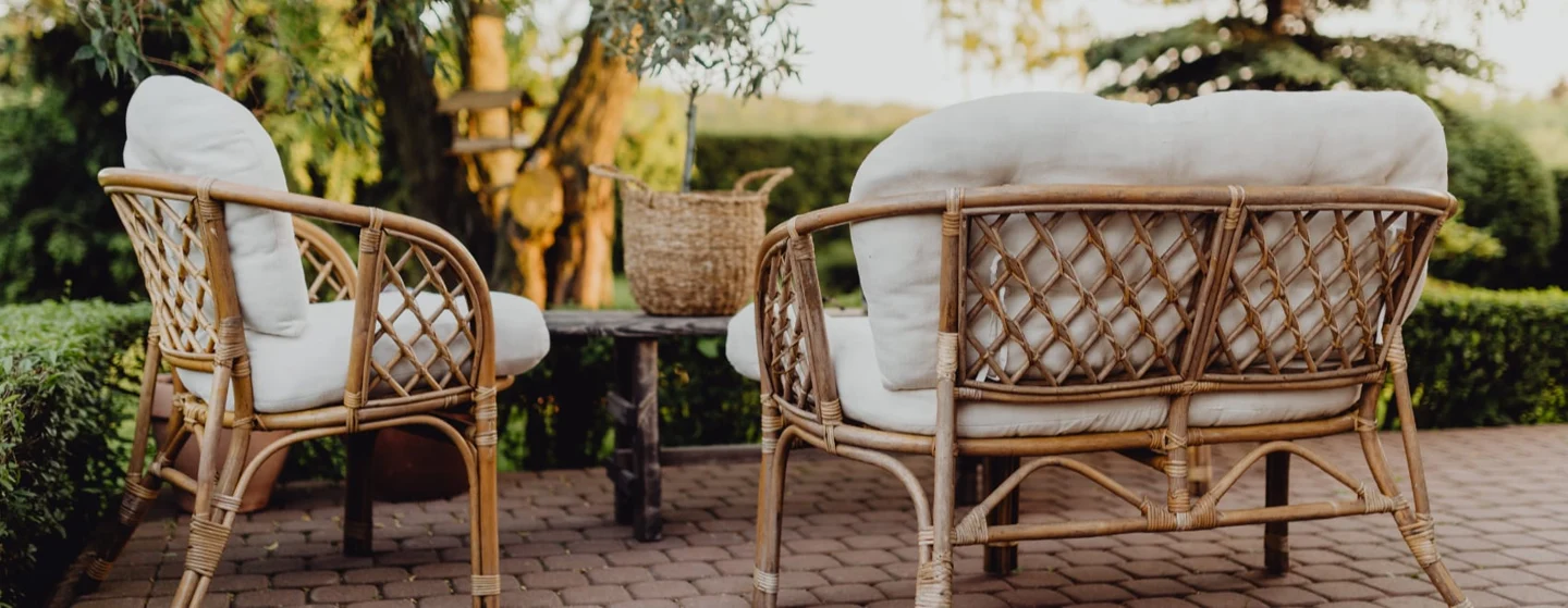 rattan furniture in the garden at sunset