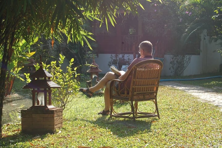 man reading under the sun