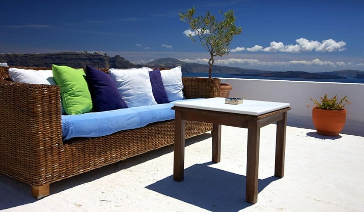 rattan garden furniture in a sunny balcony