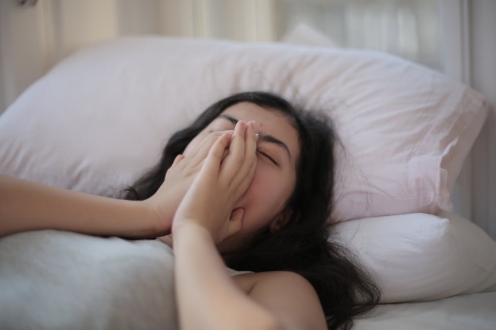 woman yawning in bed