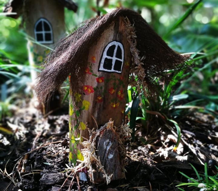 fairy garden houses amidst plants