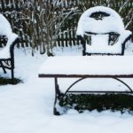 metal garden furniture covered in snow