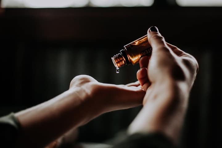 applying drops of bergamot oil