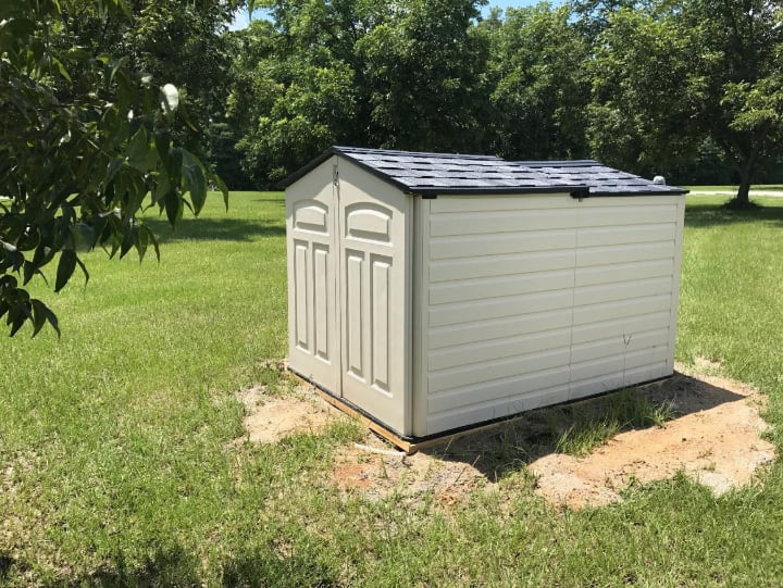 small garden shed covering a well