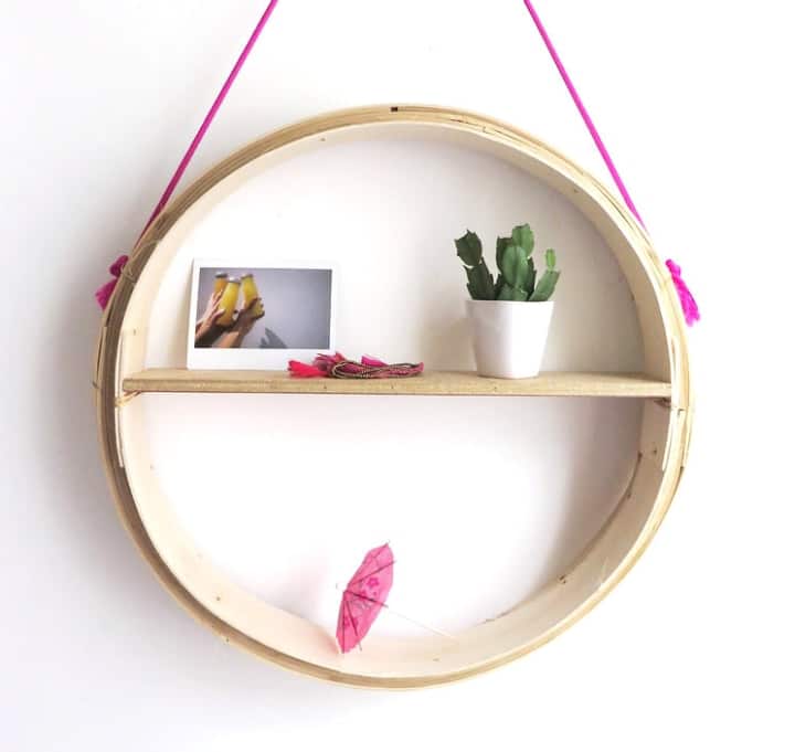 round hanging wooden shelf with houseplant