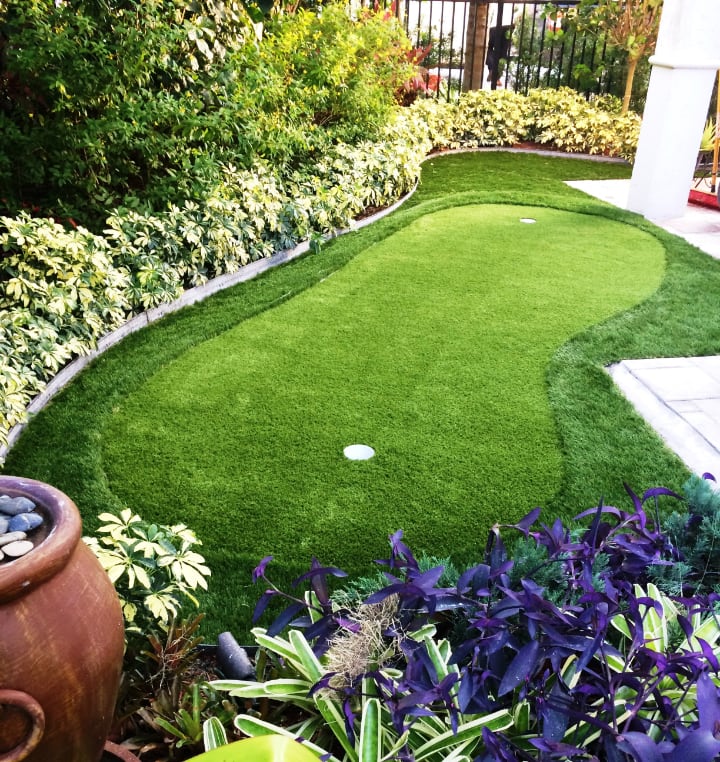 artificial grass for a low maintenance landscaping design for front lawn