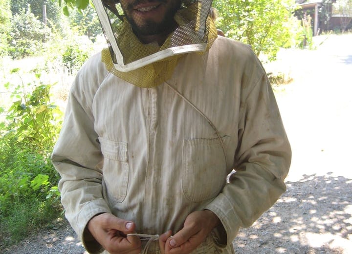 wearing protective beekeeping gear
