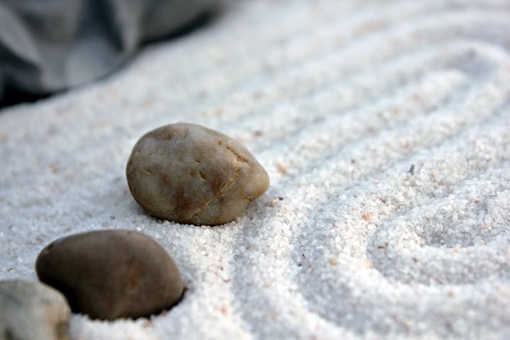 arranging rocks andsand on the zen garden