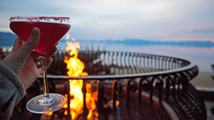 enjoying a drink in front of a firepit at dawn