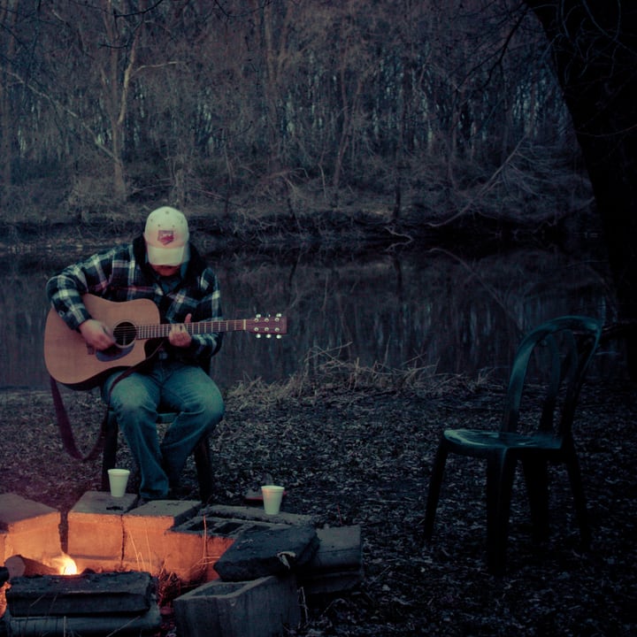 playing guitar by the fire pit