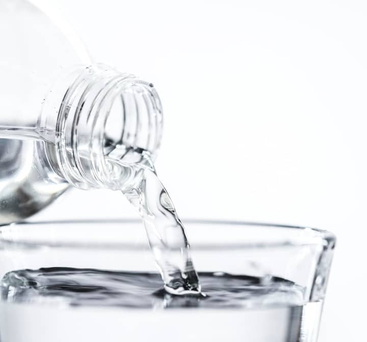 pouring water to jar