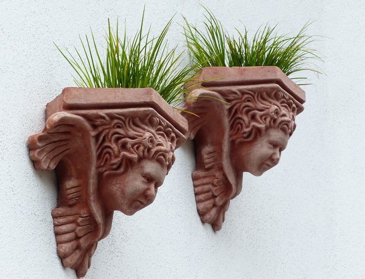 sculpture planters on white wall garden