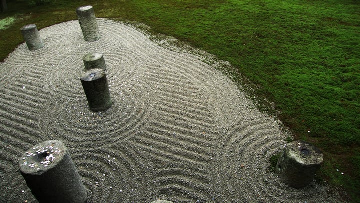 small zen garden in the corner of garden